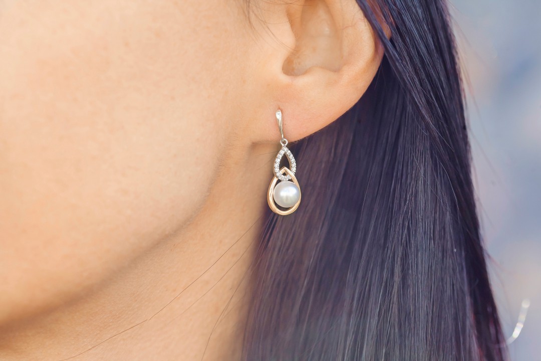 Woman ear wearing beautiful luxury earring