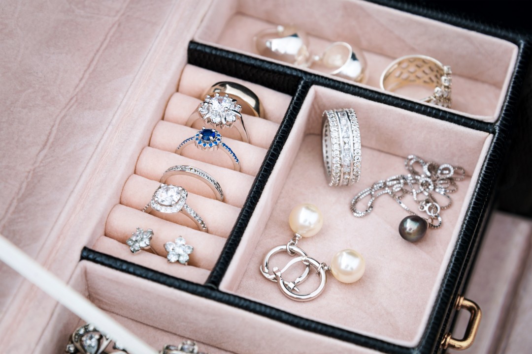 Jewelry box with white gold and silver rings, earrings and pendants with pearls. Collection of luxury jewelry.