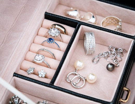 Jewelry box with white gold and silver rings, earrings and pendants with pearls. Collection of luxury jewelry.