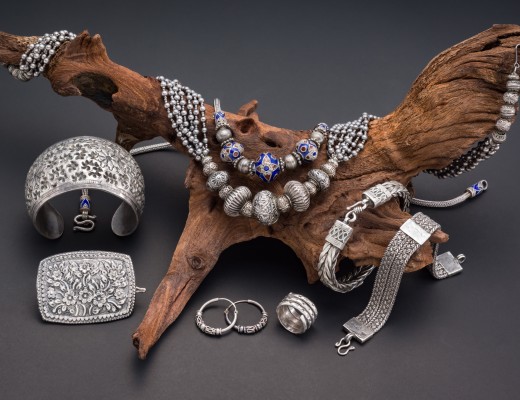 Collection of antique traditional silver jewelry on old wood and black paper