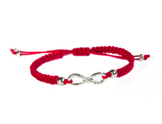 red thread bracelet with infinity on white background, handmade, friendship bracelet